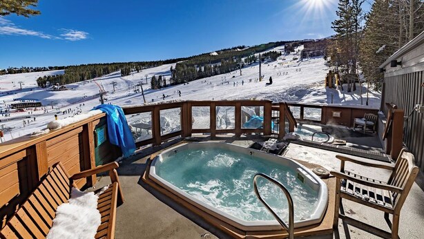A hot tub on a deck with a snowy mountain view. - Large Corner 2 Bedroom Unit Mountain Vibes (Breckenridge)