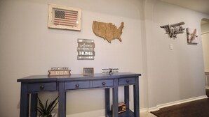 A reception desk with a sign reading "Welcome to Our Home" and a wooden map of the USA.