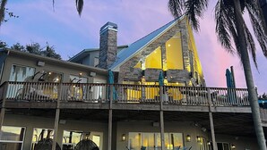 A two-story building with a balcony and outdoor seating area.