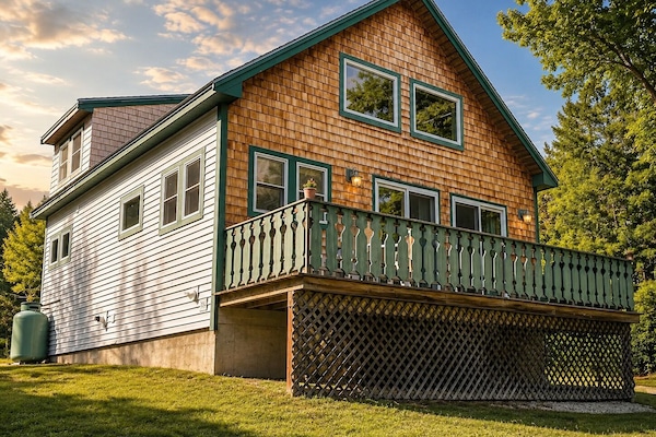 The chalet exterior with a raised deck and a setting that feels like a resort