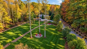 A well-maintained lawn with a circular seating area and a pathway.