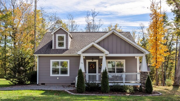 A two-story house with a front porch, a small entryway, and a garage.