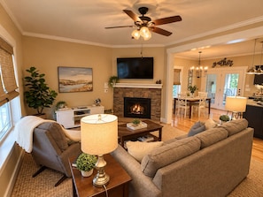 A living room with a fireplace, sofa, and television. - Private Hot Tub & Fireplace, 2 Miles from Asheville (Asheville)