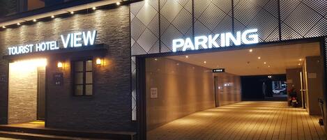A hotel entrance with a sign for "TOURIST HOTEL VIEW" and "PARKING".