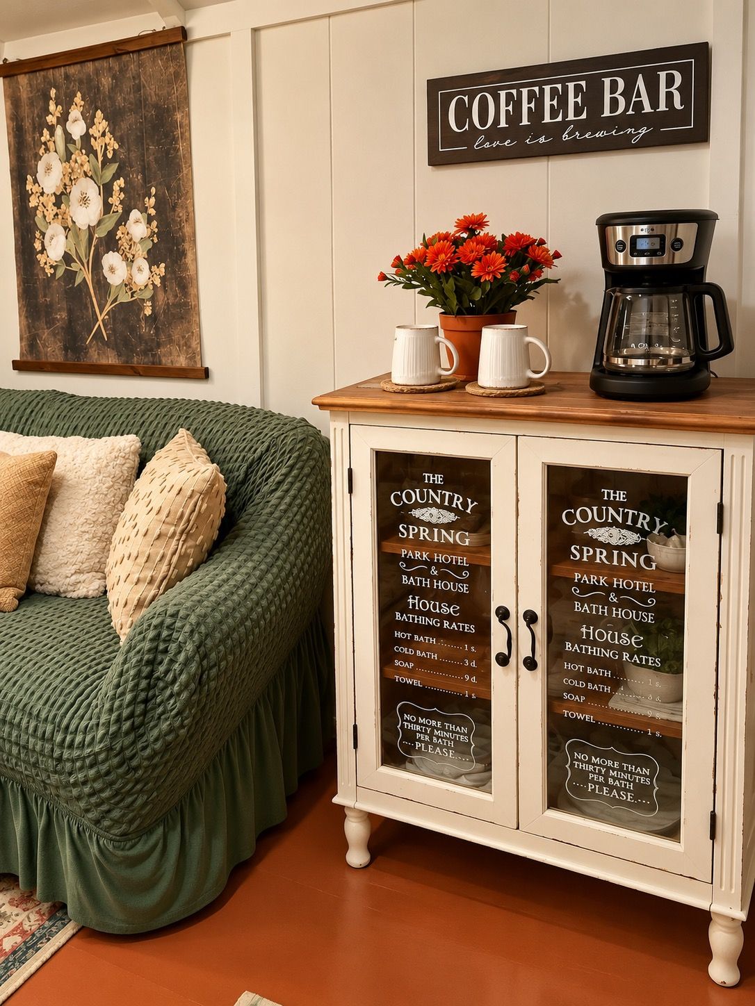 A cozy room with a green sofa, a coffee bar sign, and a cabinet with a list of amenities including a park hotel, bath house, and bathing rates.