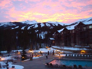 A resort with a pool, outdoor seating, and a mountain backdrop. - Studio Unit, Beautiful Luxury Ski In, Ski Out Resort (Breckenridge)