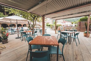Enjoy meals under the shade of a covered patio with comfortable seating for groups.