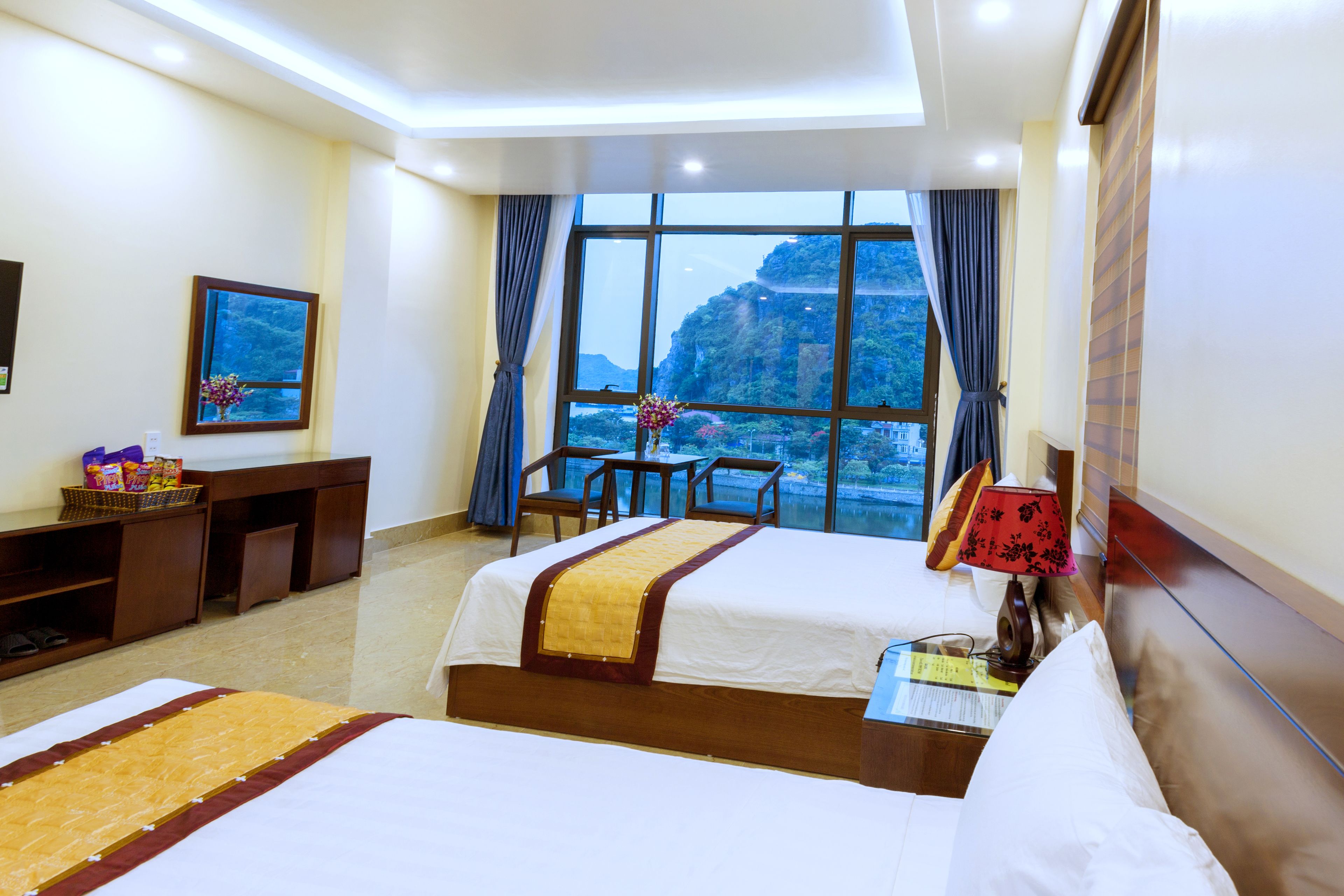 Deluxe Quadruple Room | Minibar, desk, blackout drapes, soundproofing