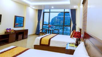 Deluxe Quadruple Room | Minibar, desk, blackout curtains, soundproofing