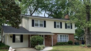 A two-story house with a front porch, a brick chimney, and a mailbox. - Clean, Spacious Family House (Annapolis)