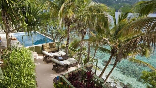 A pool area with lounge chairs and a view of the ocean. - Magens Bay Super Villa! 2024 Specials - 1or2 Nts Free 3Pools - Beach -36' Boat! (St. Thomas)
