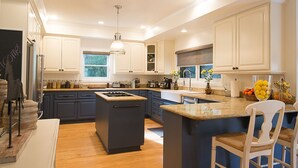 A modern kitchen with a central island, built-in appliances, and ample storage.
