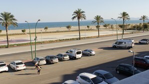 A parking lot with cars and a person walking. - Two bedroom apartment with sea views (Ampuriabrava)