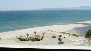 A beach with a parking lot and buildings. - FRENTE AL MAR, WIFI, 130M2 (Empuriabrava)