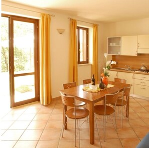 Enjoy meals in this cozy dining area with a table for four and access to an outdoor space.