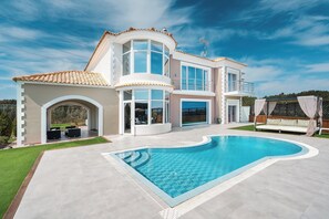 A modern two-story house with a swimming pool, large windows, and a covered outdoor seating area. - Paramithia Villa with Private Pool (Afantou)
