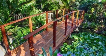 Comfortable bungalow in a garden with dense tropical vegetation