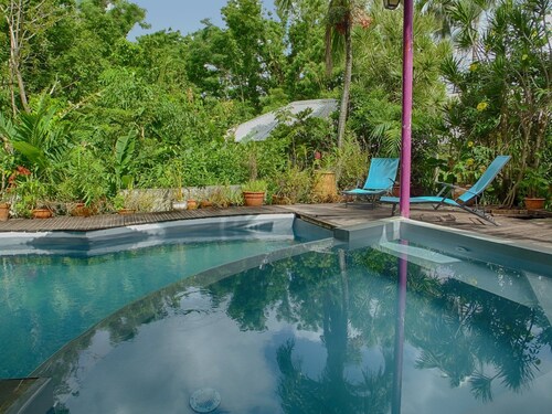 Comfortable bungalow in a garden with dense tropical vegetation