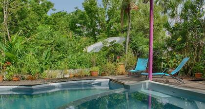 Comfortable bungalow in a garden with dense tropical vegetation