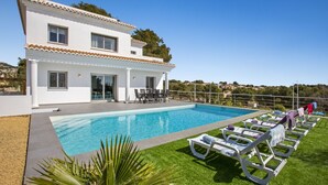 A two-story house with a swimming pool, outdoor seating, and a view of the surrounding landscape. - VALLESA - Modern villa with private pool near the beach and supermarkets (Calpe)