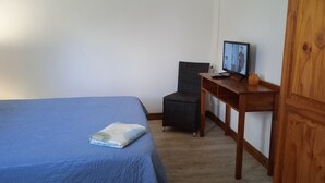 A bedroom with a bed, a desk, a chair, and a television. - Verval T1 floor "Furnished with Tourime 3 *** (Unknown)