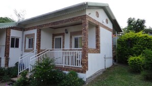 A two-story house with a brick facade, white exterior walls, and a small porch with white railings. - Verval T1 floor "Furnished with Tourime 3 *** (Unknown)