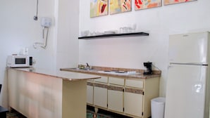 A compact kitchen with a microwave, coffee maker, and a refrigerator. - Gladioli 1101 - That's all Puerto Rico (Ponce Pueblo)