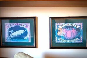 Two framed signs on a wall, one labeled 'Waverly' and the other 'Tomatoes.'