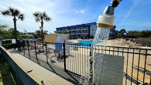 Relax by the pool surrounded by lounge chairs and umbrellas.