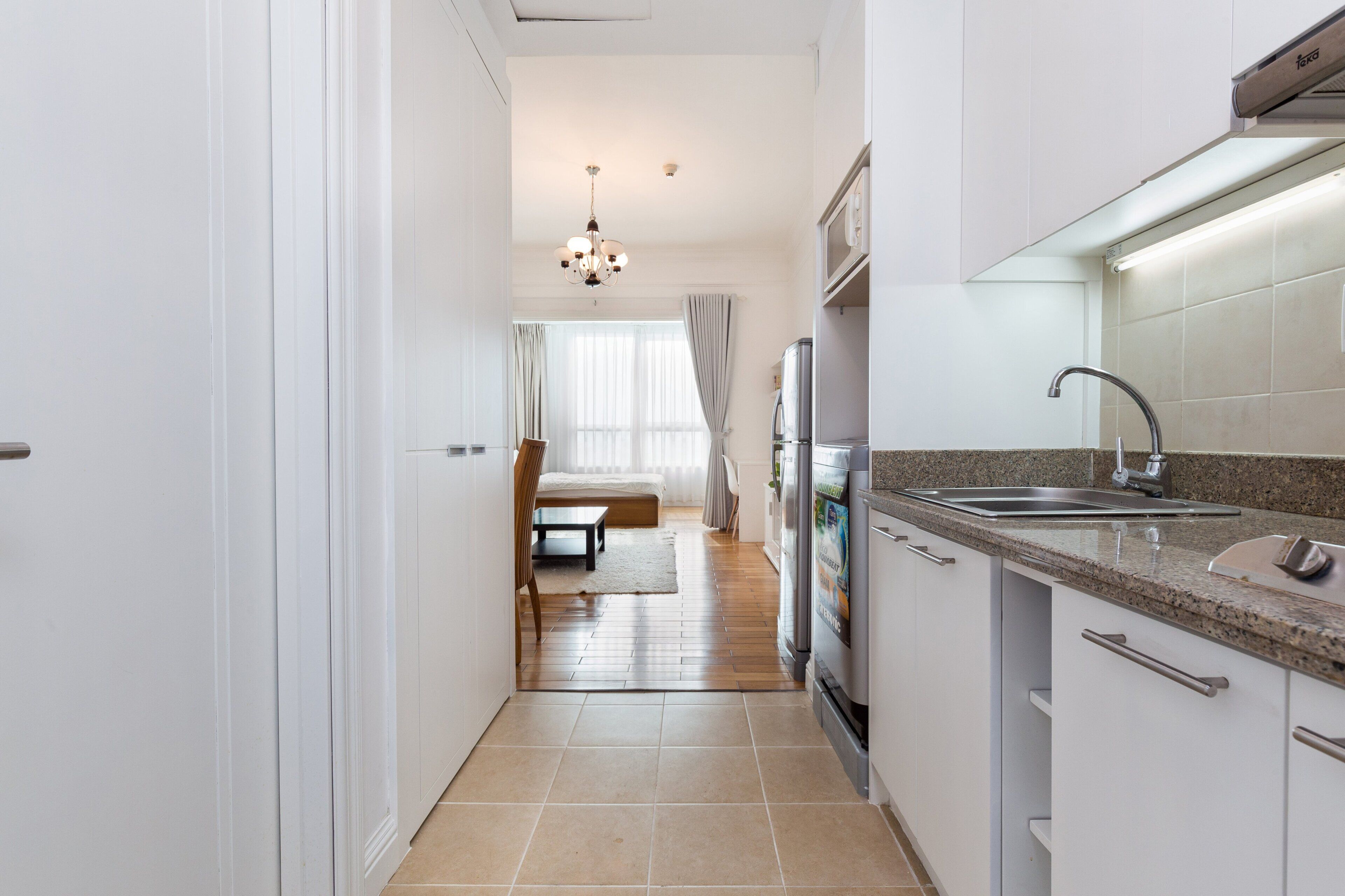 A modern kitchen with a granite countertop, stainless steel appliances, and a built-in oven.