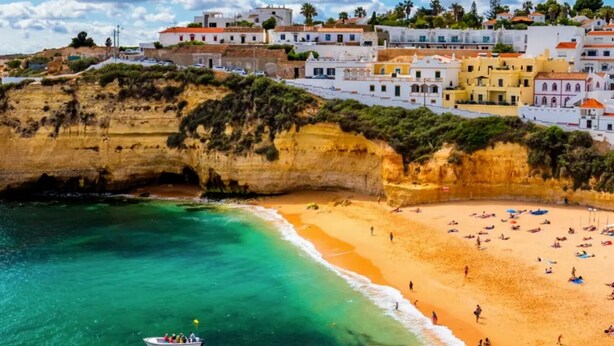 A coastal town with a beach, cliffs, and colorful buildings. - Luxury detached villa with tropical garden and large private pool. Fully walled (Carvoeiro)