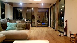 A modern living room with a sofa, a coffee table, and a wine rack. - Luxury detached villa with tropical garden and large private pool. Fully walled (Carvoeiro)