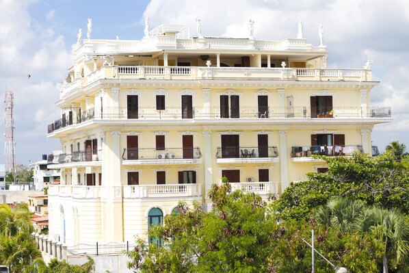 A multi-story building with balconies, large windows, and a classical architectural style.