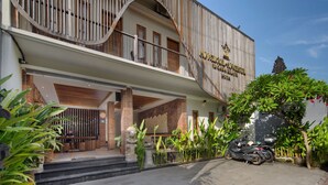 A two-story building with a wooden facade, a balcony, and a sign that reads "Angkor Wat". - Angkul Angkul Segara Beach Kuta (Kuta)