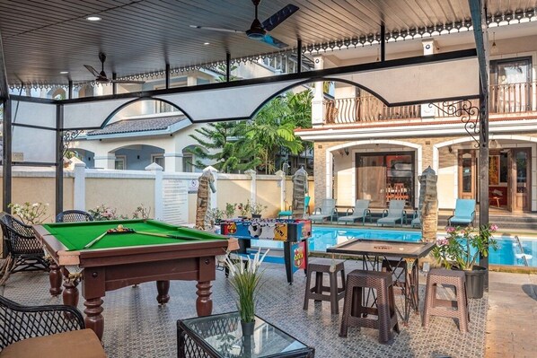 Relax and socialize in our indoor recreational area, featuring a pool table, foosball table, and comfortable seating.
