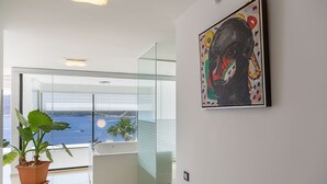 A modern interior with a large window overlooking a scenic view, a white bathtub, and a potted plant. - Villa Setara is a rare beach front property located in Kalkan (Kalkan)