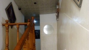 A staircase with wooden balusters and marble steps. - Pridemark Hotel (Abuja)