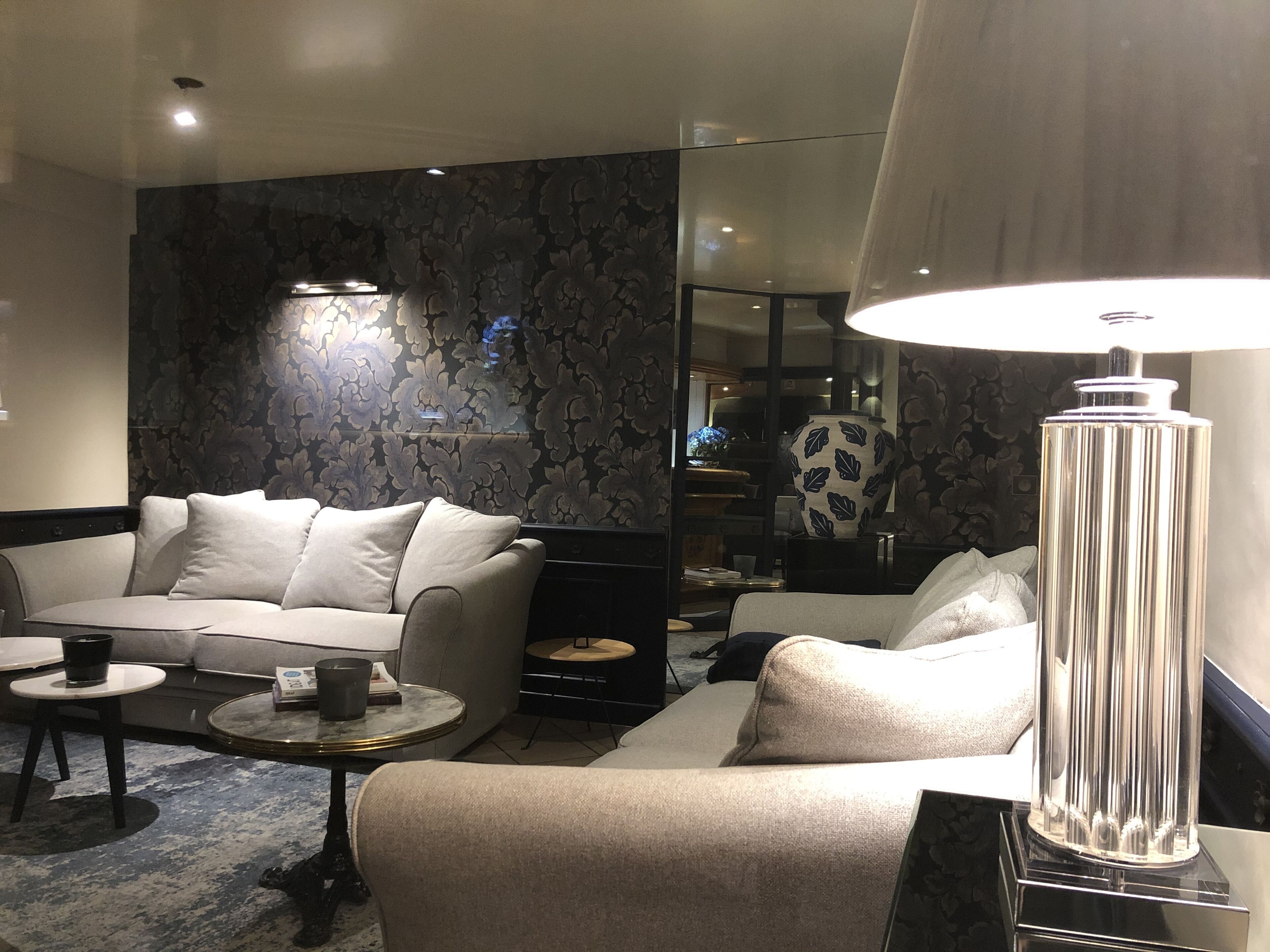 A modern living room with a sofa, coffee table, and decorative lamp.