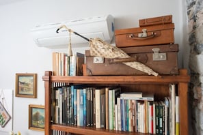 Ein Bücherregal mit Büchern und einem alten Koffer.