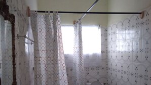 A bathroom with a sink, toilet, and shower curtain.