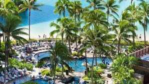 A resort with a beach, pool, and palm trees. - 1519 · Ilikai Collection # 9. Beachfront Resort, upgraded (Honolulu)