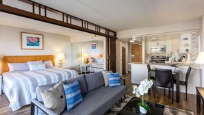 A hotel room with a bed, a sofa, a dining area, and a kitchen. - 1519 · Ilikai Collection # 9. Beachfront Resort, upgraded (Honolulu)