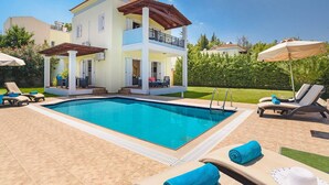 A two-story house with a swimming pool, outdoor seating, and a covered patio. - Apollon - Seven Springs Villas (Rhodes)