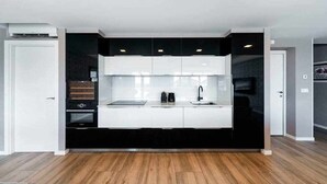 A modern kitchen with a central island, built-in appliances, and a sleek design.