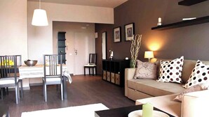 A modern living room with a sofa, dining table, chairs, and a coffee table. - Incredible apartment-central-sea view-near the beach-Free Wifi. (Barcelona)