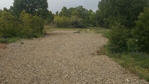A gravel path surrounded by dense greenery and trees. - Horny toad point RV space  up above Dolores Colorado book today great view s!  (Dolores)