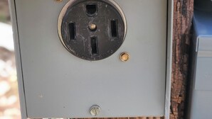 A utility box with a circular electrical outlet, a metal screw, and a cable connected to it. - Horny toad point RV space  up above Dolores Colorado book today great view s!  (Dolores)