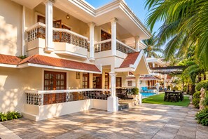 A multi-story hotel with balconies, a swimming pool, and a well-maintained garden. - 10BHK Private Family Friendly Self Catered Villa - 2 min walk to Calangute beach (Calangute)