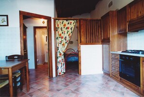 Enjoy meals in this cozy kitchen with a dining table and chairs, stove, and oven.