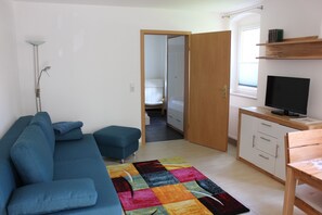 Deluxe Apartment, 1 Bedroom, Kitchen, Garden View (Dresden) | Living area | 32-inch flat-screen TV with satellite channels, TV - Weber Apartments (Dresden)